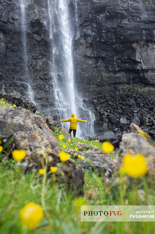 Tourist at the Fossá waterfall, the highest waterfall in the Faroe Islands, Streymoy island, Faeroe islands, Denmark, Europe
